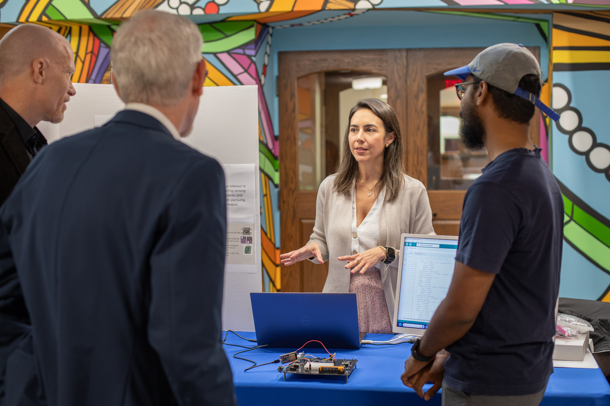 Andrea Ramirez-Salgado, and Ed Tech doctoral candidate, presents her research to an audience at Norman Hall.