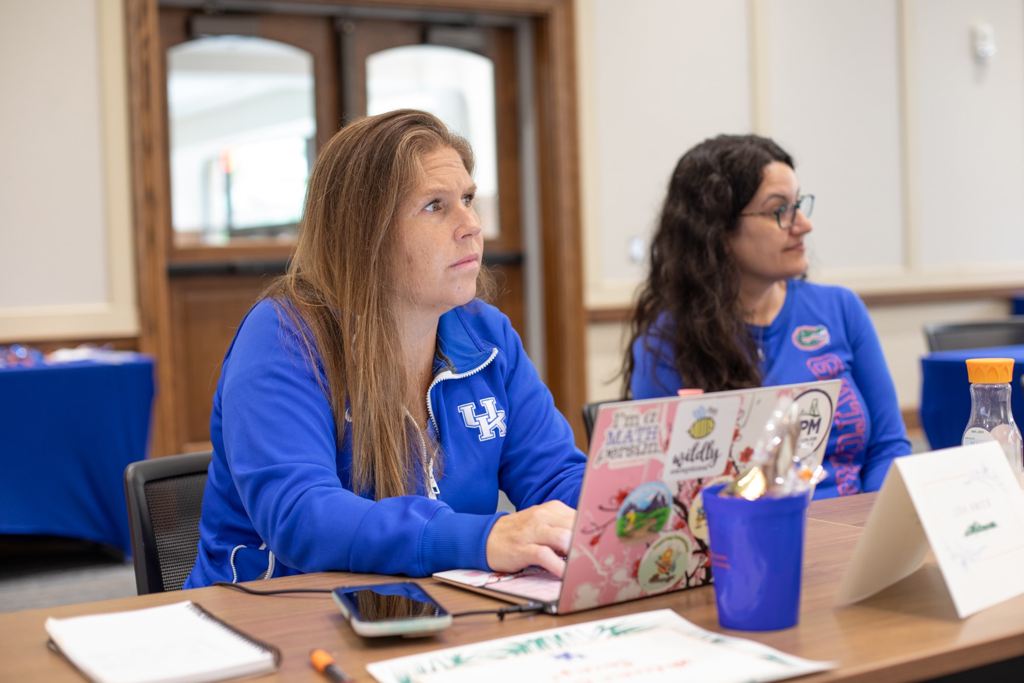 Four people looking at an iPad together and smiling.