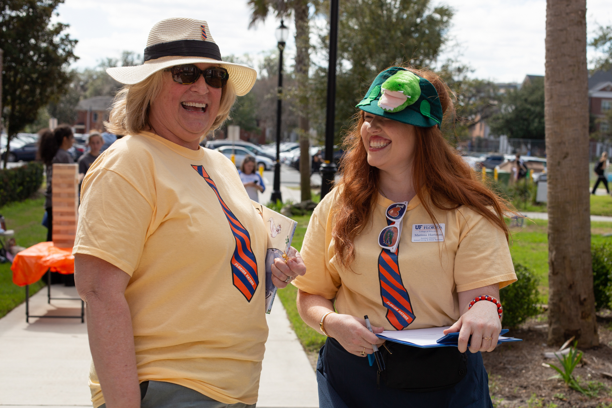 Two people standing together wearing hats