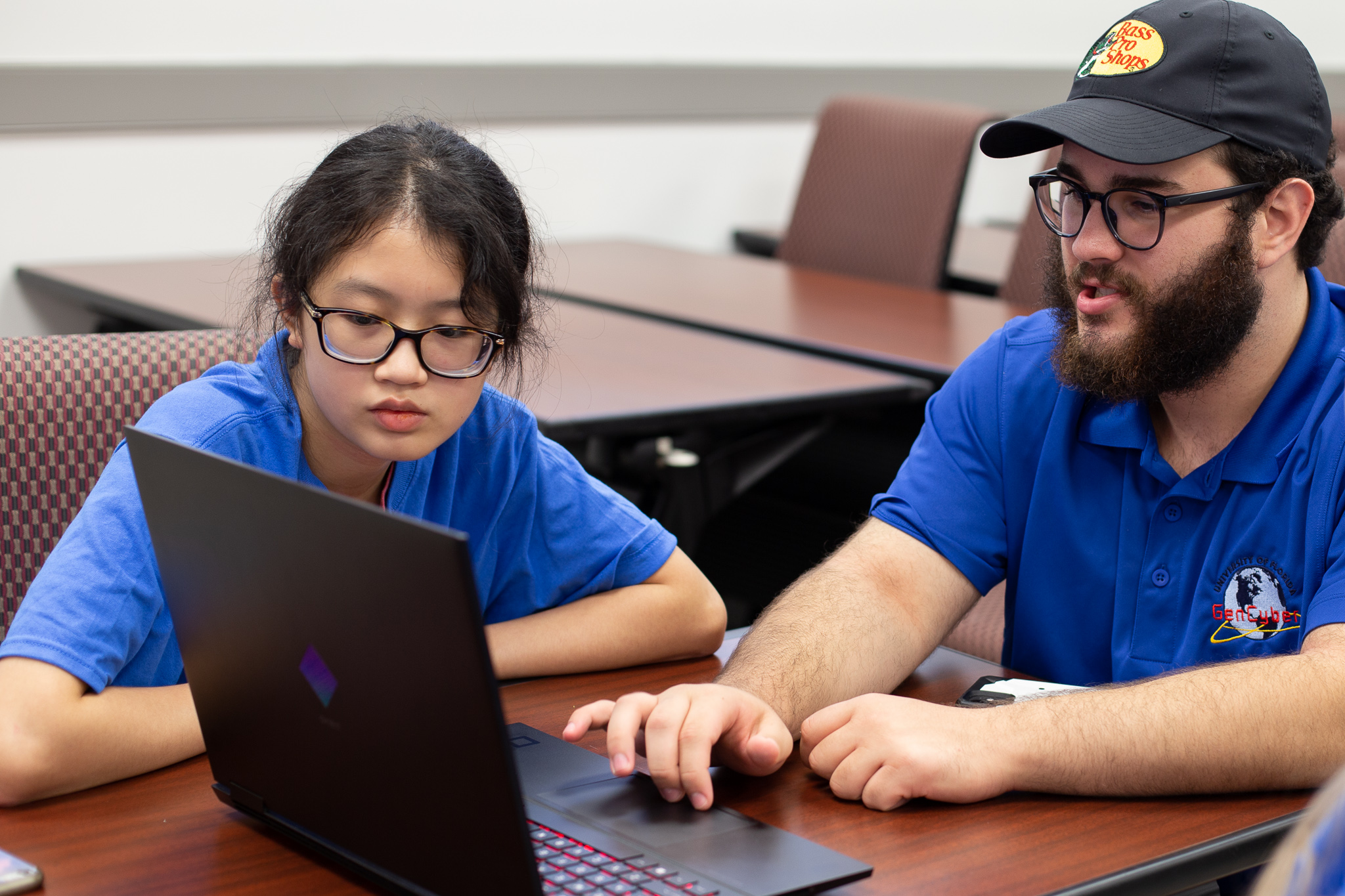 Two people looking at a laptop