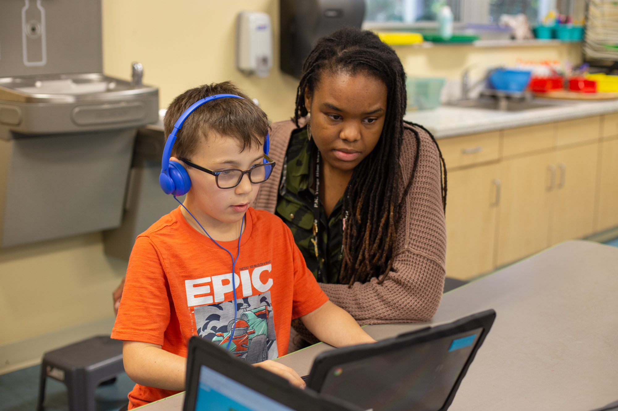 Ed Tech B-Roll-16 a teacher instructing a student on how to use a laptop